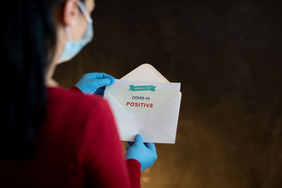 Midsection of woman holding umbrella