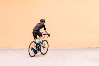 Side view of man riding bicycle