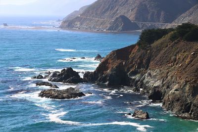 Scenic view of sea by cliff