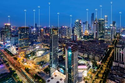 High angle view of illuminated buildings in city at night