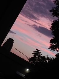 Low angle view of silhouette trees against sky at sunset