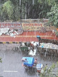 People working on wet floor during rainy season