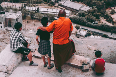 Rear view of people sitting at temple