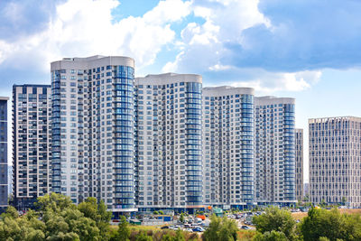 White and blue facades of new residential high-rise buildings in a residential area of the city.