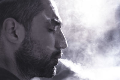 Close-up portrait of young man looking away