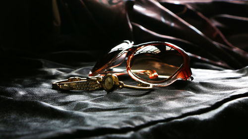 Close-up of wedding rings on bed