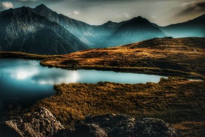 Scenic view of lake and mountains against sky