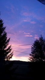 Silhouette trees against sky at sunset