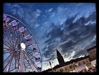 Low angle view of ferris wheel against sky