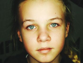 Close-up of girl standing by wall