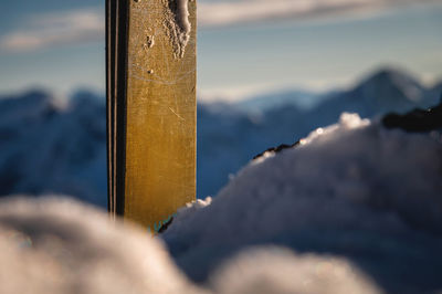 Skiing. close-up of the top of the skis, snow is falling, with snow-capped mountains in the