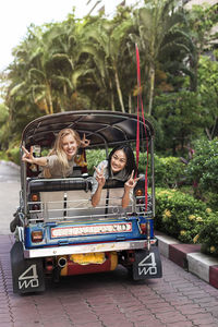Young women in rickshaw, bangkok, thailand