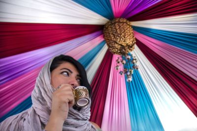 Portrait of a beautiful young woman drinking turkish coffee