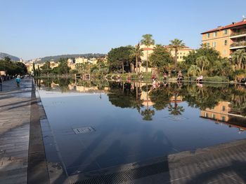 Reflection of trees and buildings in lake