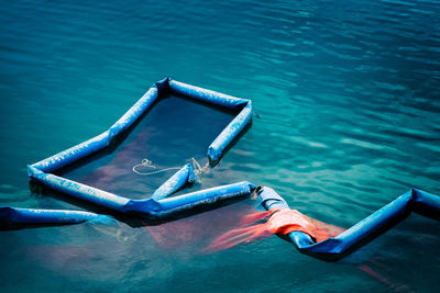 Broken barriers for water containment in a sea harbor during construction works 