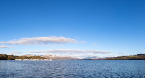 Scenic view of lake against blue sky