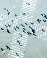 High angle view of people crossing road in city