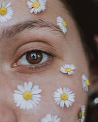 Close-up portrait of person on flowering plant