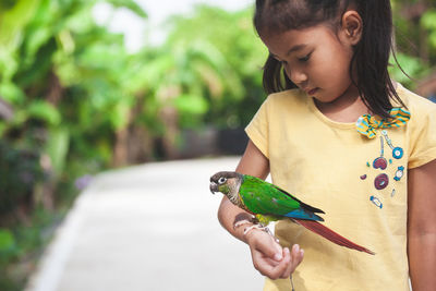 Girl holding bird