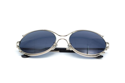 Close-up of sunglasses against white background