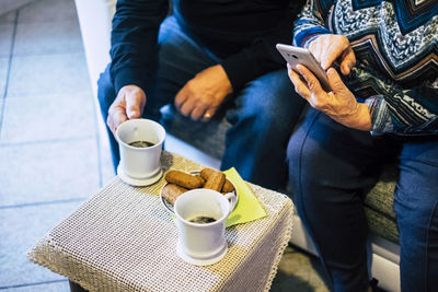 Midsection of couple having tea