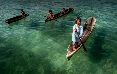 High angle view of people enjoying in sea
