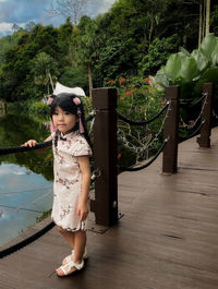 Side view of girl standing on road