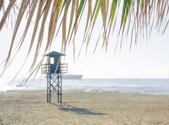 Lifeguard hut on beach against sky