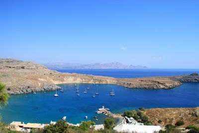 High angle view of sea against clear blue sky