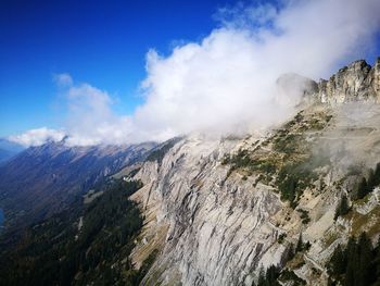 Scenic view of mountains against cloudy sky