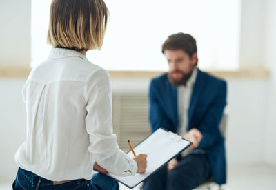 Side view of young man working at office