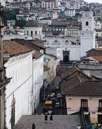 High angle view of people walking on street amidst buildings in city