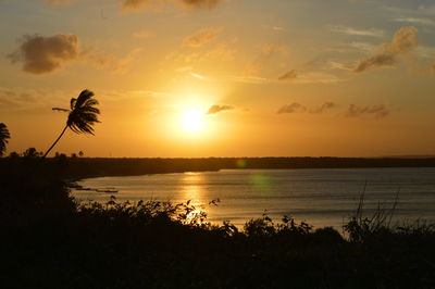 Scenic view of lake against orange sky