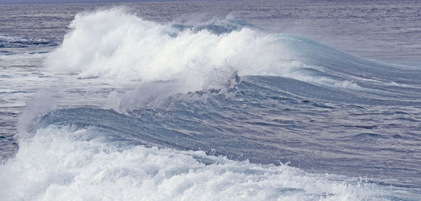 Waves breaking against sea