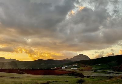 Scenic view of field against sky during sunset