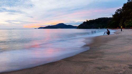 Scenic view of beach against sky during sunset