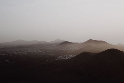 Scenic view of silhouette mountains against sky