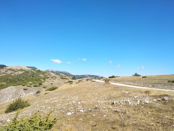 Scenic view of land against clear blue sky