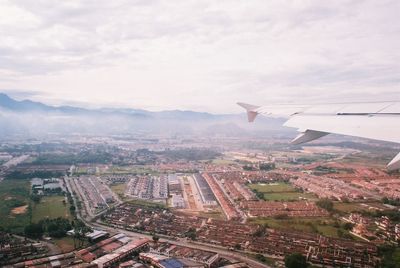 Aerial view of city against sky