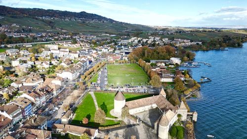 High angle view of townscape by sea against sky