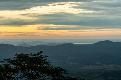Scenic view of mountains against sky at sunset