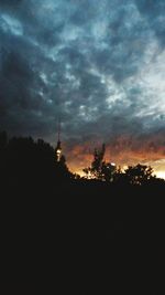 Silhouette of building against dramatic sky