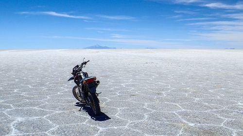 Motorcycle parked on salt flat at salar de uyuni