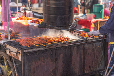 Man preparing food at market stall