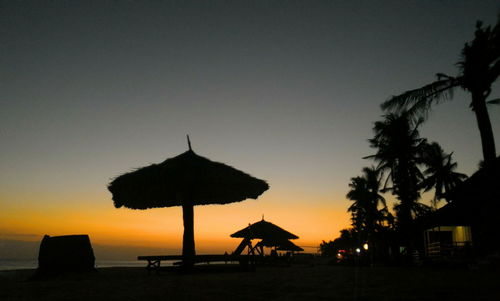 Silhouette of palm trees at sunset