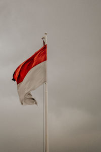 Low angle view of flag against the sky