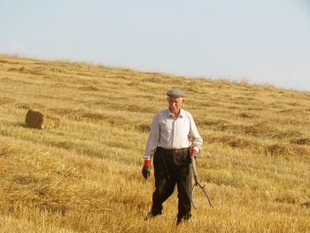 Portrait of man standing on field