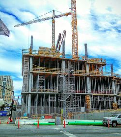 Low angle view of cranes at construction site