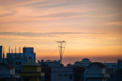 Buildings against sky during sunset
