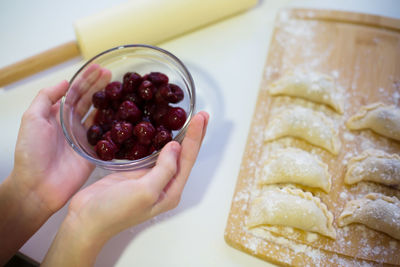 Cropped hand of person holding food